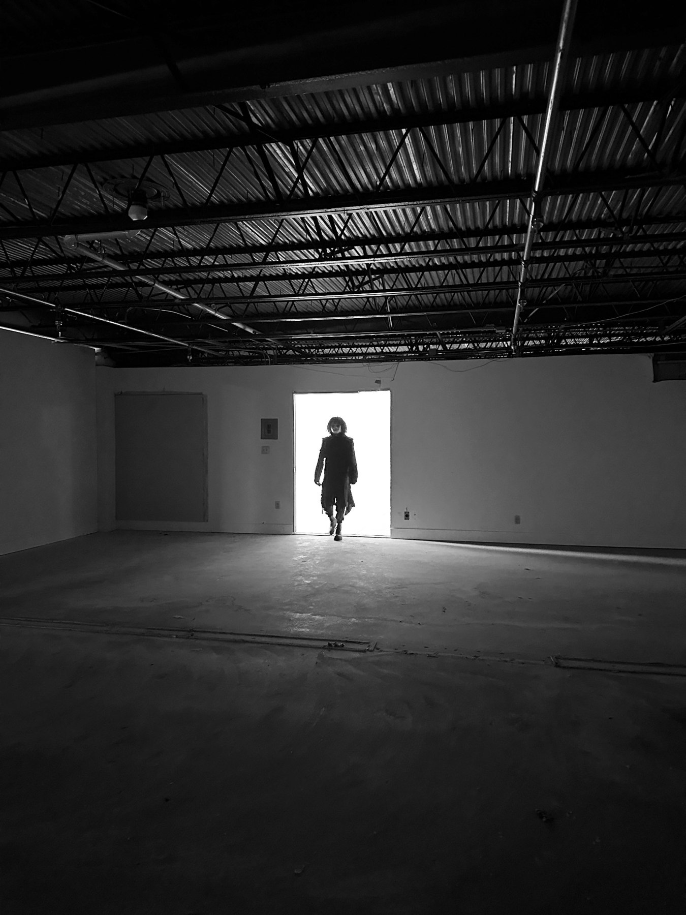 Phantomix silhouetted in an illuminated doorway