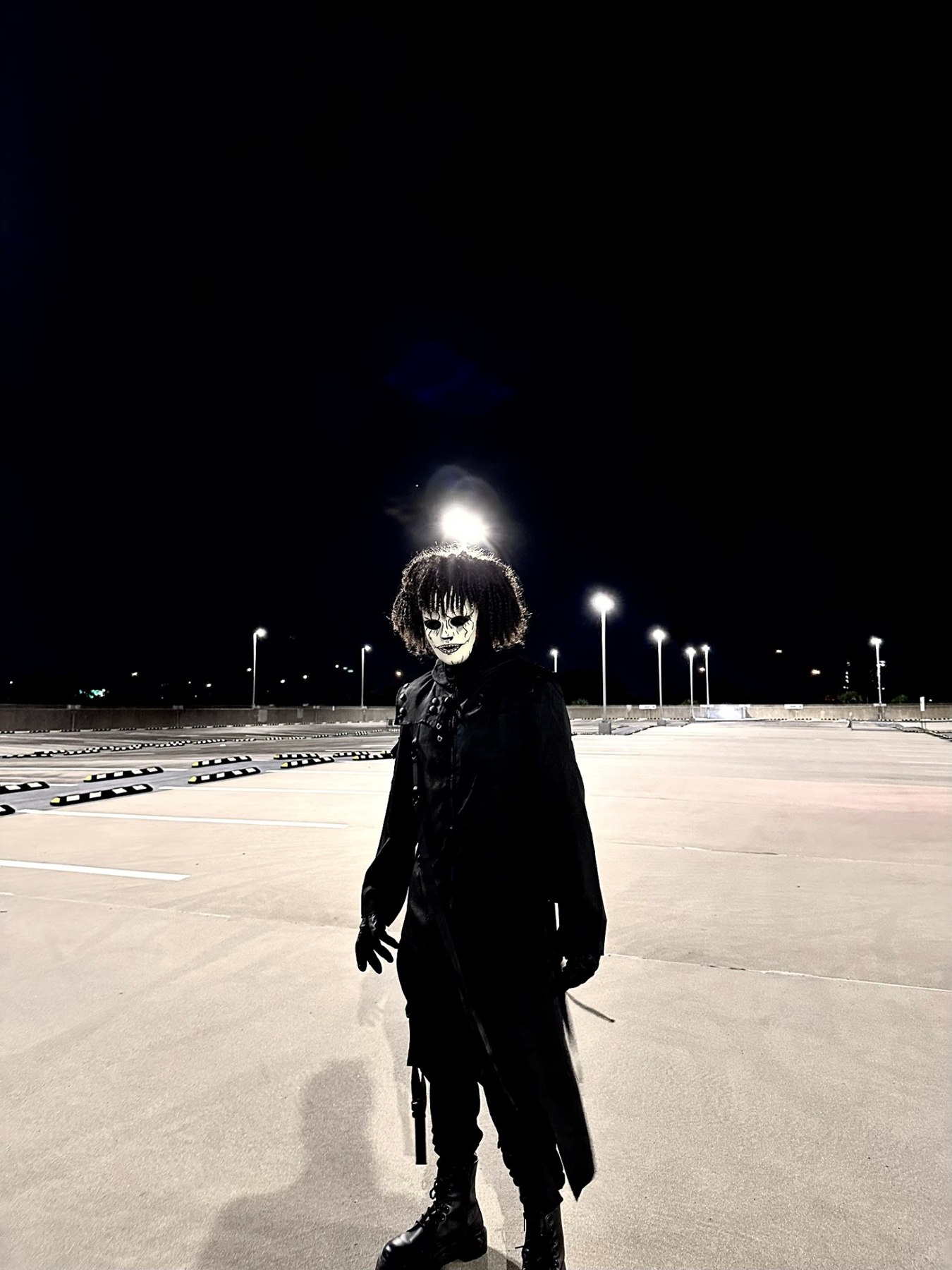 Phantomix alone in a parking lot at night